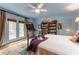 Charming bedroom with French doors leading to an outdoor patio, and a bookcase at 657 E Paces Ferry Ne Rd, Atlanta, GA 30305