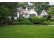 Charming white home with a well-manicured front yard and vibrant landscaping at 657 E Paces Ferry Ne Rd, Atlanta, GA 30305