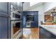 Modern kitchen featuring navy cabinets, stainless steel appliances, and hardwood floors at 657 E Paces Ferry Ne Rd, Atlanta, GA 30305