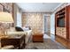 Cozy living room with patterned wallpaper, comfortable seating, and built-in shelves at 657 E Paces Ferry Ne Rd, Atlanta, GA 30305
