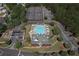 Aerial view of the community pool, tennis courts, clubhouse and ample parking surrounded by mature trees at 110 Serendipity Way, Dallas, GA 30157