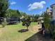 Large backyard with a well maintained lawn featuring a trampoline, patio and mature trees at 110 Serendipity Way, Dallas, GA 30157