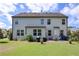 Backyard featuring outdoor dining on the patio, grill, and spacious yard at 110 Serendipity Way, Dallas, GA 30157