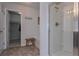 Bright bathroom with a walk-in shower, a wooden stool, and access to a walk-in closet for ultimate convenience at 110 Serendipity Way, Dallas, GA 30157