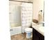 Cozy bathroom featuring a white shower-tub combination and a neutral-toned vanity with granite countertop at 110 Serendipity Way, Dallas, GA 30157