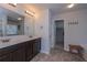 Elegant bathroom with dual sinks, large mirror, modern lighting, and easy access to walk-in closet at 110 Serendipity Way, Dallas, GA 30157
