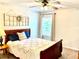 Inviting bedroom with vintage window decor above a wooden sleigh bed with floral patterned comforter at 110 Serendipity Way, Dallas, GA 30157