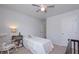 Bright bedroom with ceiling fan, a twin bed and a rocking chair, creating a cozy and inviting space at 110 Serendipity Way, Dallas, GA 30157