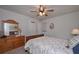 Traditional bedroom with a dark wood bed frame, soft natural light, and hardwood dresser at 110 Serendipity Way, Dallas, GA 30157