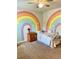 Charming bedroom featuring a whimsical rainbow wall mural and cozy carpeting at 110 Serendipity Way, Dallas, GA 30157
