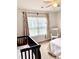 Bright Bedroom with rainbow wall art, a dark wood crib, and natural light from the large window at 110 Serendipity Way, Dallas, GA 30157