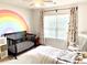 Bright Bedroom with rainbow wall art, a dark wood crib, and natural light from the large window at 110 Serendipity Way, Dallas, GA 30157
