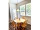 Bright dining area features a wooden table and chairs by windows that provide plenty of natural light at 110 Serendipity Way, Dallas, GA 30157
