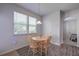 Cozy dining area with a round table, wood chairs, and natural light from a bright window at 110 Serendipity Way, Dallas, GA 30157