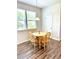Dining area features light-colored wood table and chairs, and natural light at 110 Serendipity Way, Dallas, GA 30157
