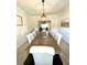 Elegant dining room featuring a large wooden table, upholstered chairs, and stylish lighting for memorable gatherings at 110 Serendipity Way, Dallas, GA 30157