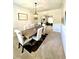 Elegant dining room boasts a wooden table, upholstered chairs, stylish lighting, and a view to a comfortable living space at 110 Serendipity Way, Dallas, GA 30157