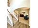 Inviting entryway with wood floors and carpeted stairs leading into a carpeted living area with stylish furnishings at 110 Serendipity Way, Dallas, GA 30157