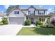 Charming two-story home with manicured lawn, two car garage, and inviting front porch at 110 Serendipity Way, Dallas, GA 30157