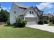 Side view of a two-story home with attached garage and a lush, green lawn at 110 Serendipity Way, Dallas, GA 30157