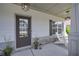 Inviting front porch with stone accents, seating area, and ambient lighting at 110 Serendipity Way, Dallas, GA 30157