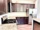 Bright kitchen features granite countertops, stainless steel appliances, and dark wood cabinets at 110 Serendipity Way, Dallas, GA 30157