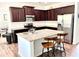 Well-lit kitchen featuring granite countertops, stainless steel appliances, and dark wood cabinets at 110 Serendipity Way, Dallas, GA 30157
