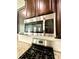 Modern kitchen features stainless steel microwave and gas range at 110 Serendipity Way, Dallas, GA 30157