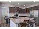 Kitchen with dark cabinetry, granite counters, stainless appliances, and seating at island at 110 Serendipity Way, Dallas, GA 30157