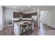 Eat-in kitchen with an island, stainless steel appliances, granite countertops and dark wood cabinets at 110 Serendipity Way, Dallas, GA 30157