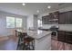 Bright eat-in kitchen boasts granite countertops, stainless steel appliances, and dark cabinets at 110 Serendipity Way, Dallas, GA 30157