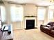 Cozy living room featuring a fireplace with white mantle and windows with white drapes at 110 Serendipity Way, Dallas, GA 30157