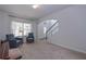 Inviting living room with carpeted floors, arched entryway, a window and a staircase leading to the upper level at 110 Serendipity Way, Dallas, GA 30157