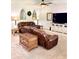 Bright living room featuring brown leather furniture, ceiling fan and stylish decor at 110 Serendipity Way, Dallas, GA 30157