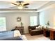 Bright main bedroom with tray ceilings, neutral decor, and side sitting area at 110 Serendipity Way, Dallas, GA 30157