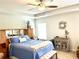 Bright main bedroom with tray ceilings, neutral decor, and ceiling fan at 110 Serendipity Way, Dallas, GA 30157