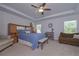 Spacious main bedroom features a tray ceiling, ceiling fan, and natural light, with comfortable seating areas at 110 Serendipity Way, Dallas, GA 30157