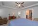 This spacious main bedroom boasts tray ceilings, an inviting desk area, and convenient access to the ensuite bathroom at 110 Serendipity Way, Dallas, GA 30157