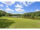 Picturesque community pond with lush green surroundings, offering a peaceful setting for residents at 110 Serendipity Way, Dallas, GA 30157