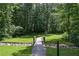 Charming walking bridge offers scenic views as it meanders through the lush, green community at 110 Serendipity Way, Dallas, GA 30157