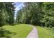 Well-maintained community walking trail surrounded by mature trees, inviting residents to explore nature at 110 Serendipity Way, Dallas, GA 30157