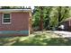 Exterior side of the brick home with a window and a glimpse of the backyard at 2545 Saint Patrick Se St, Atlanta, GA 30317