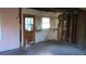 Renovation in progress showcasing exposed studs and plumbing next to a vintage window and doorway at 2545 Saint Patrick Se St, Atlanta, GA 30317