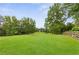 Expansive lush green lawn with mature trees, offering a serene and private outdoor space, perfect for recreation at 4002 Joshua Ln, Douglasville, GA 30135