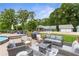 Stunning backyard featuring an expansive patio with outdoor furniture, a grill, and views of the charming house at 4002 Joshua Ln, Douglasville, GA 30135