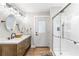 Stylish bathroom featuring a double vanity, walk-in shower, and a door to the backyard at 4002 Joshua Ln, Douglasville, GA 30135