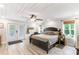 Bright bedroom featuring a king-size bed, French doors, and natural light at 4002 Joshua Ln, Douglasville, GA 30135