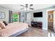 Comfortable bedroom with stylish decor, ceiling fan and mounted TV at 4002 Joshua Ln, Douglasville, GA 30135