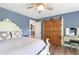 Bright bedroom with a king-sized bed, barn door, and natural light at 4002 Joshua Ln, Douglasville, GA 30135
