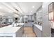 Open concept kitchen featuring an island with a marble countertop, gray cabinets, and stainless steel appliances at 4002 Joshua Ln, Douglasville, GA 30135